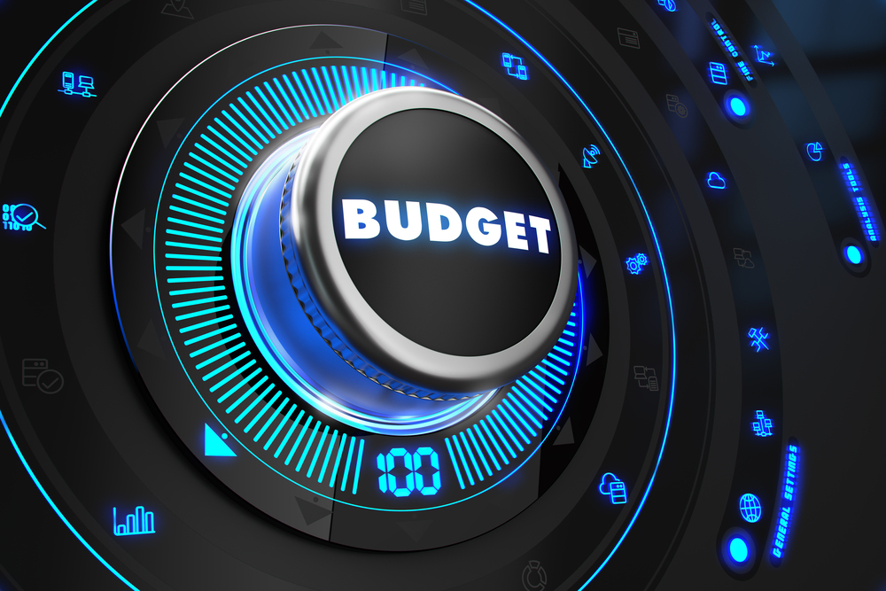 Budget Controller on Black Control Console with Blue Backlight. Improvement, regulation, control or management concept. Budget Controller on Black Control Console with Blue Backlight. Improvement, regulation, control or management concept.